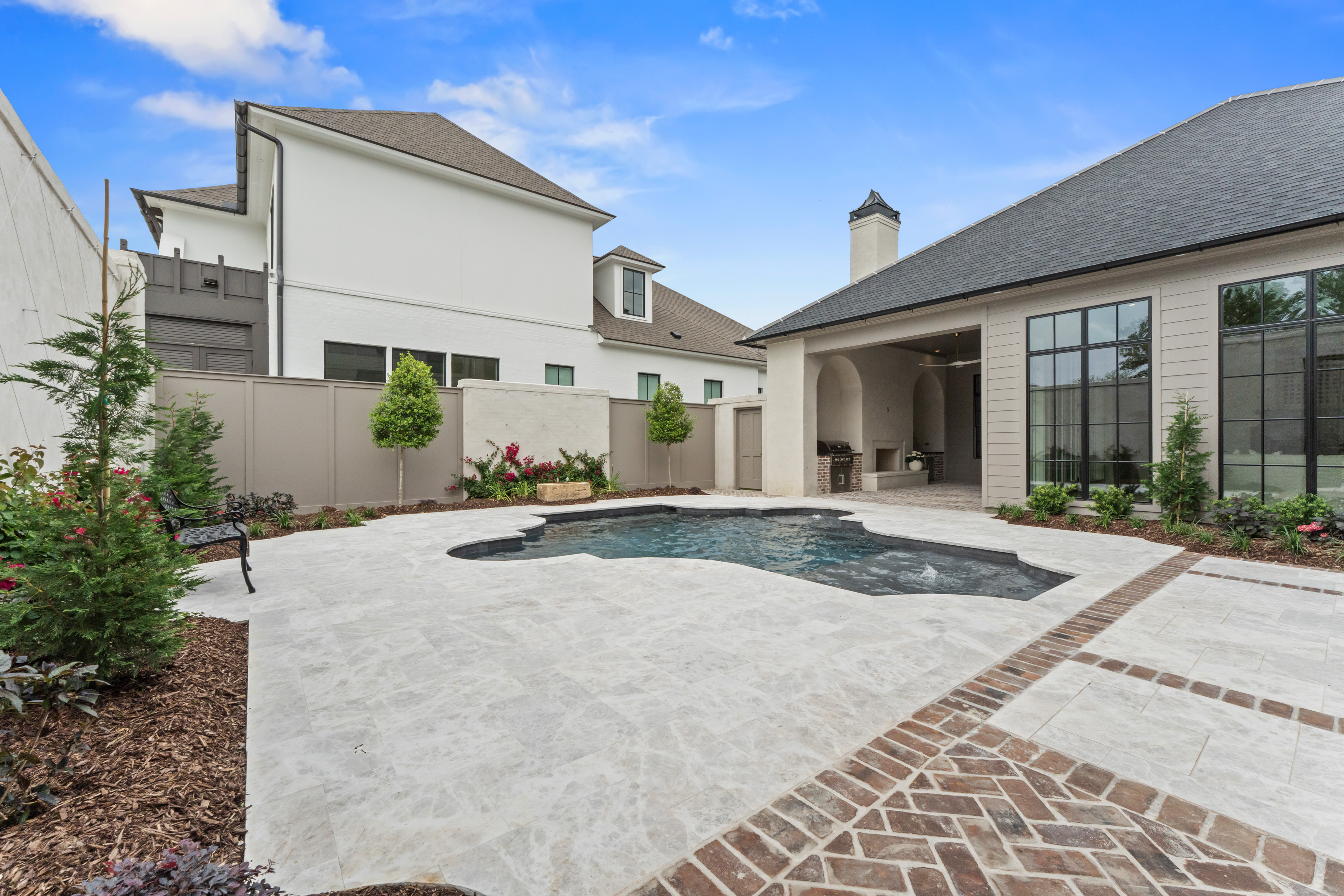 Custom home exterior and pool requiring seasonal property care